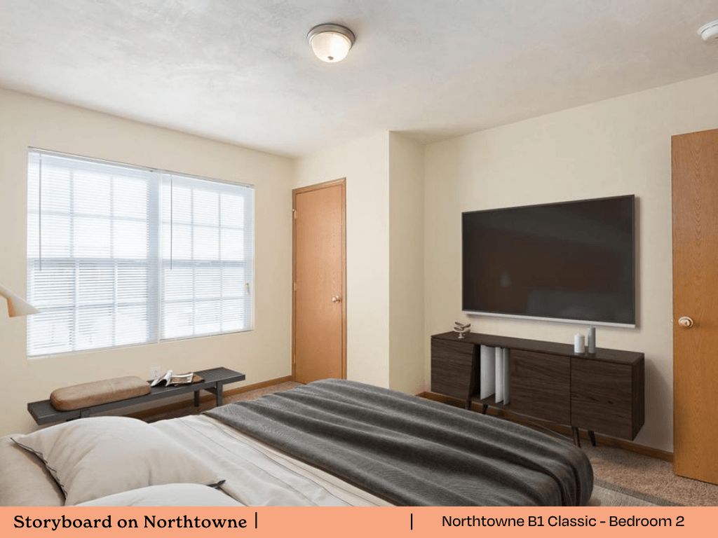 a bedroom with a bed and a television