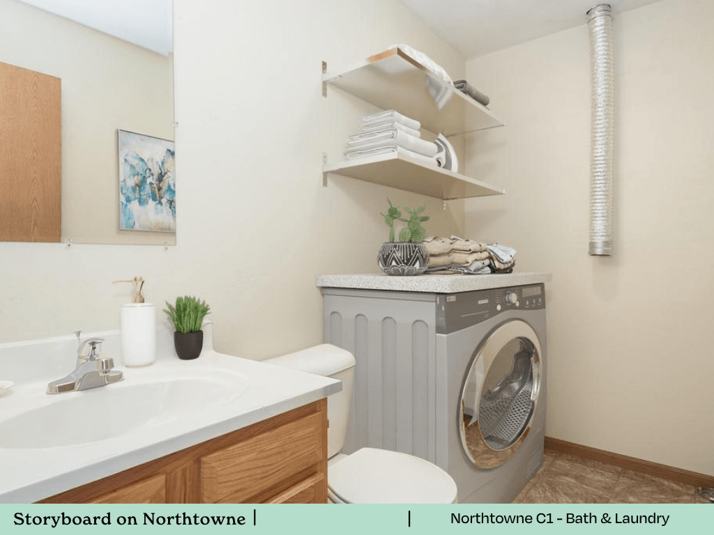 a bathroom with a washing machine and a sink and a toilet