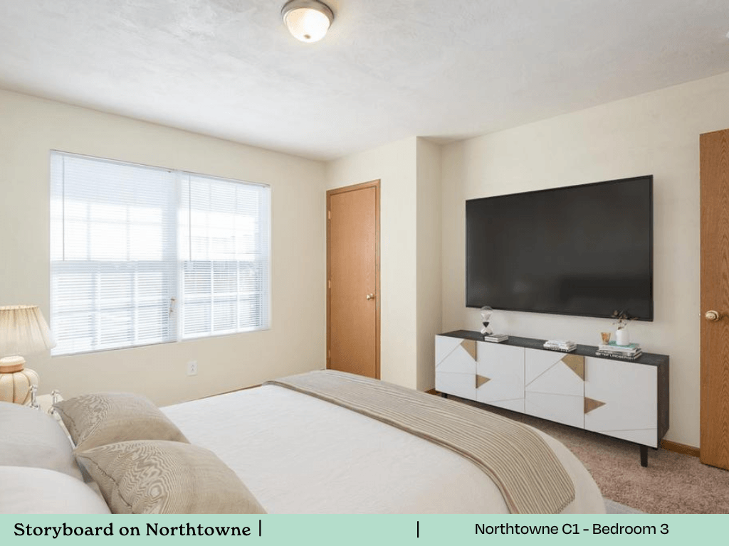 a bedroom with a bed and a tv