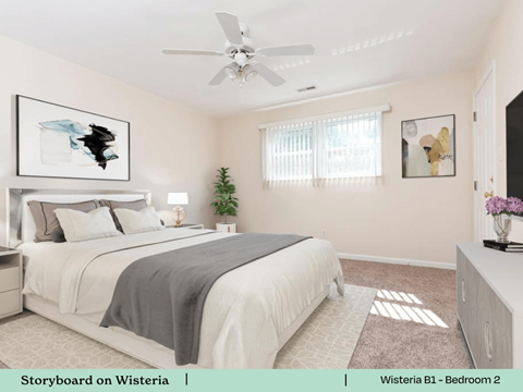 a bedroom with a bed and a ceiling fan