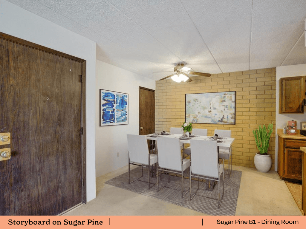 a dining room with a table and chairs and a brick wall