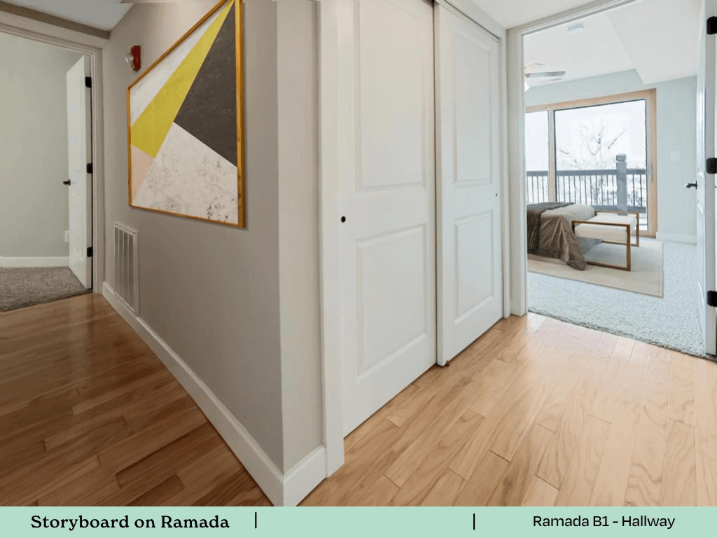 a view of a living room and a hallway with wood flooring and a door
