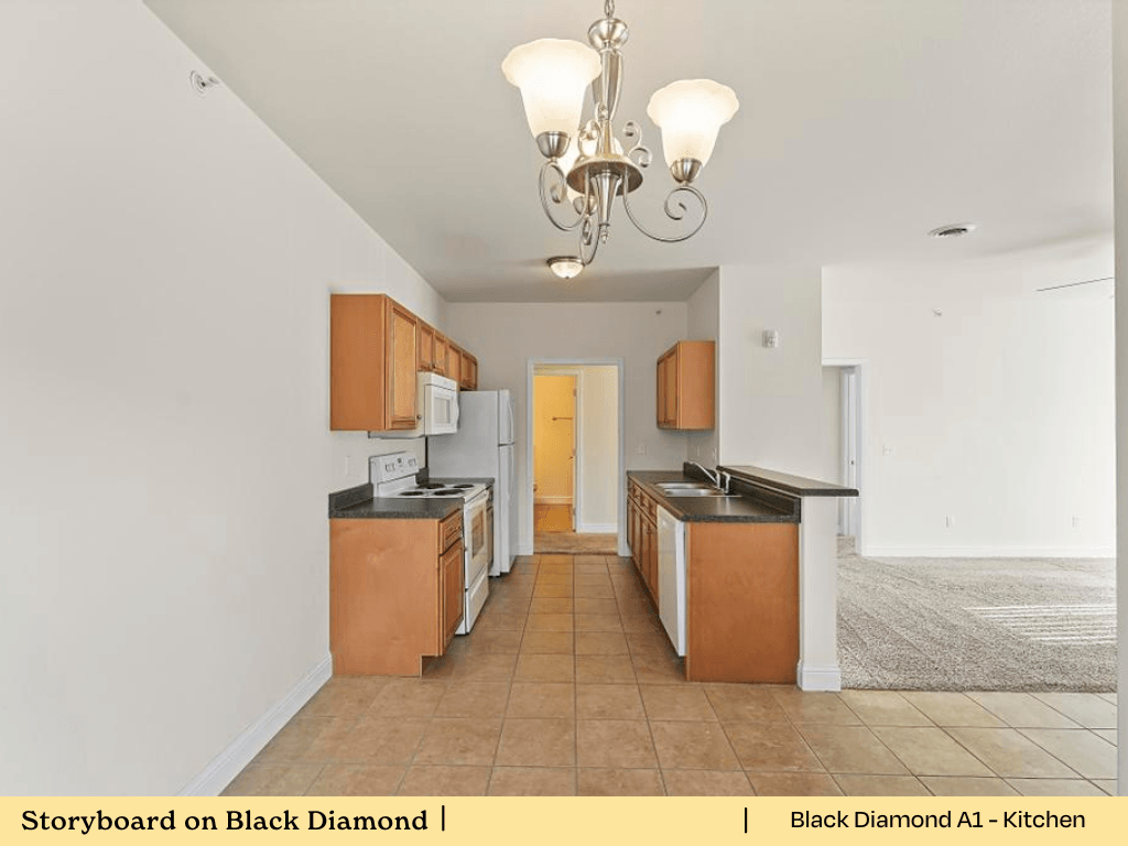 a kitchen with a long counter top and a refrigerator
