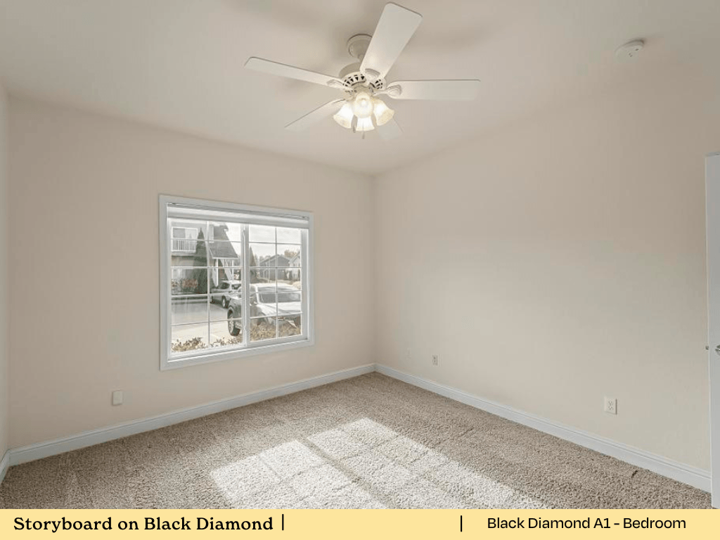 an empty bedroom with a ceiling fan and a window