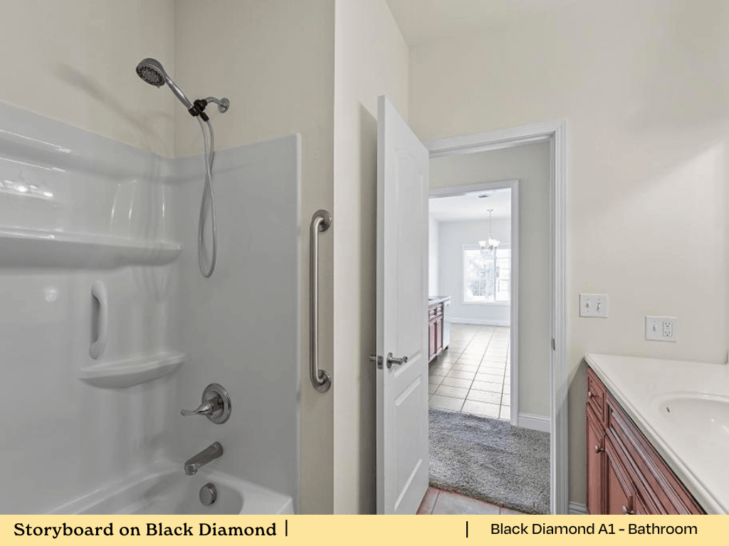 a white bathroom with a shower and a sink