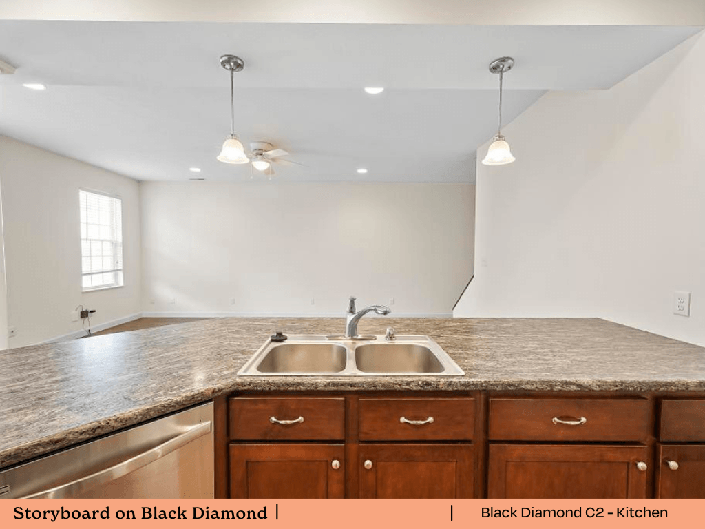 an empty kitchen with a sink and a counter top