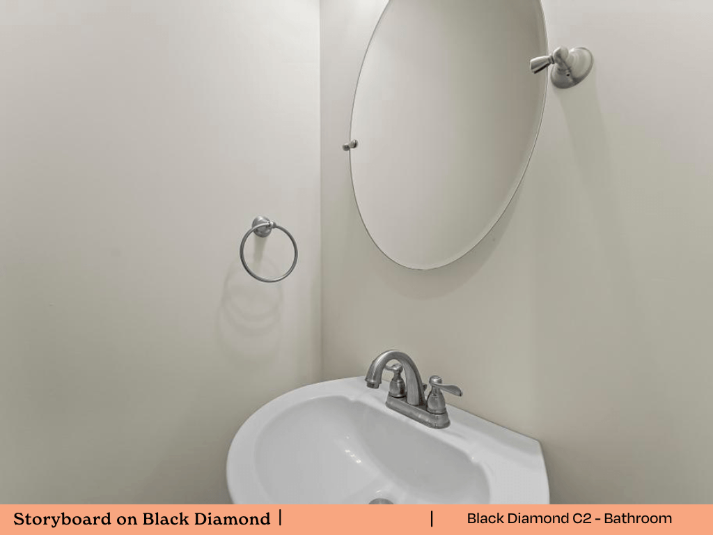 a white bathroom with a white sink and a mirror