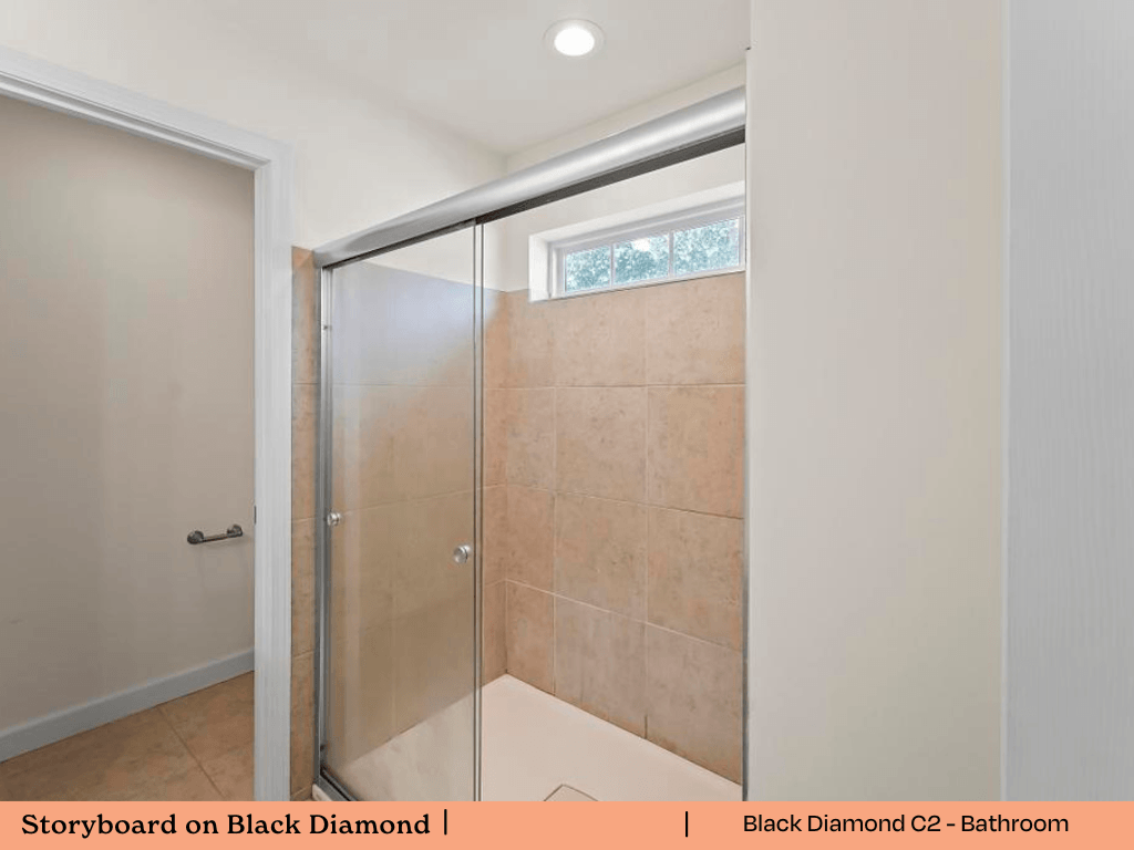 a bathroom with a shower with a glass door