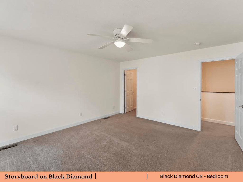 an empty living room with white walls and a ceiling fan