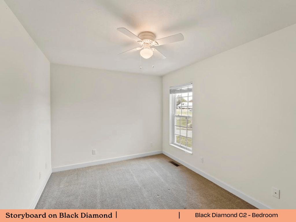 an empty bedroom with white walls and a ceiling fan
