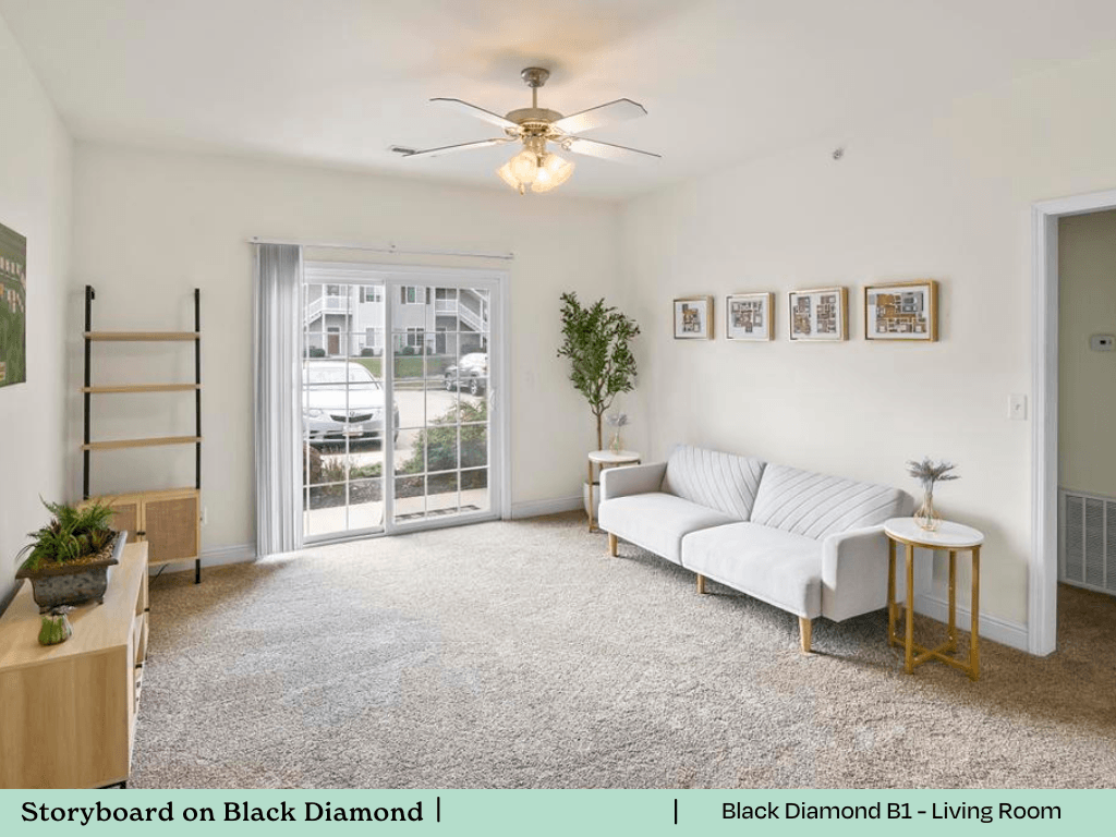 a living room with a white couch and a ceiling fan