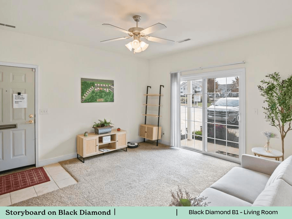 a living room with a white couch and a ceiling fan