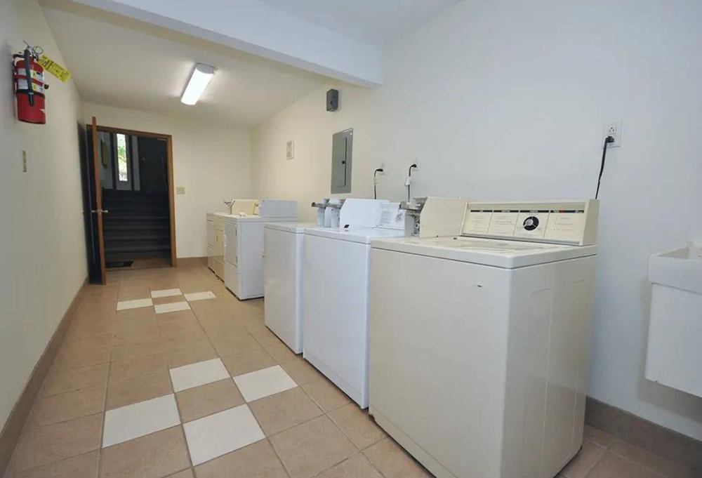 a group of washers and dryers in a room
