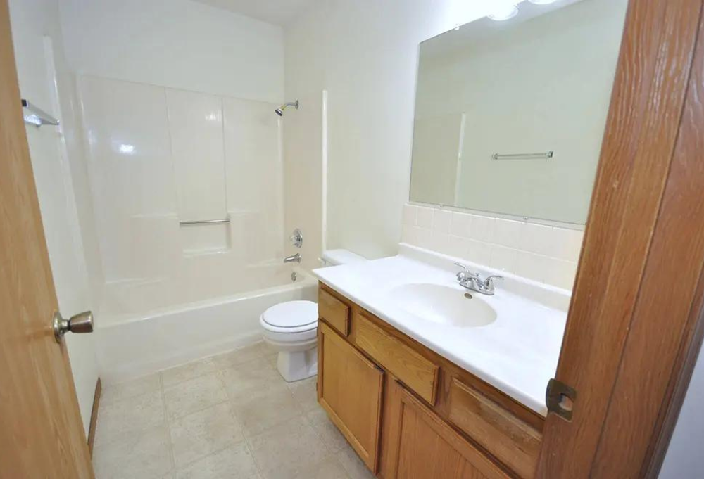 a bathroom with a sink toilet and a mirror