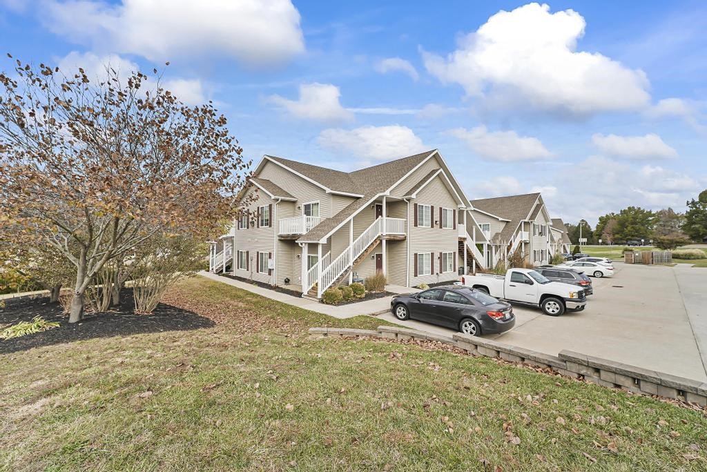a rendering of a row of houses with cars parked in a parking lot