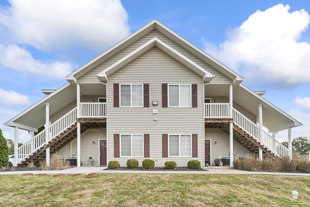 the front of a house with a porch and stairs