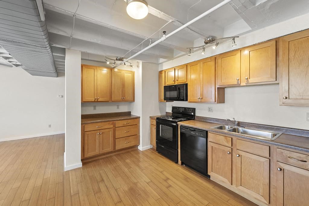 a kitchen with a stove top oven next to a sink