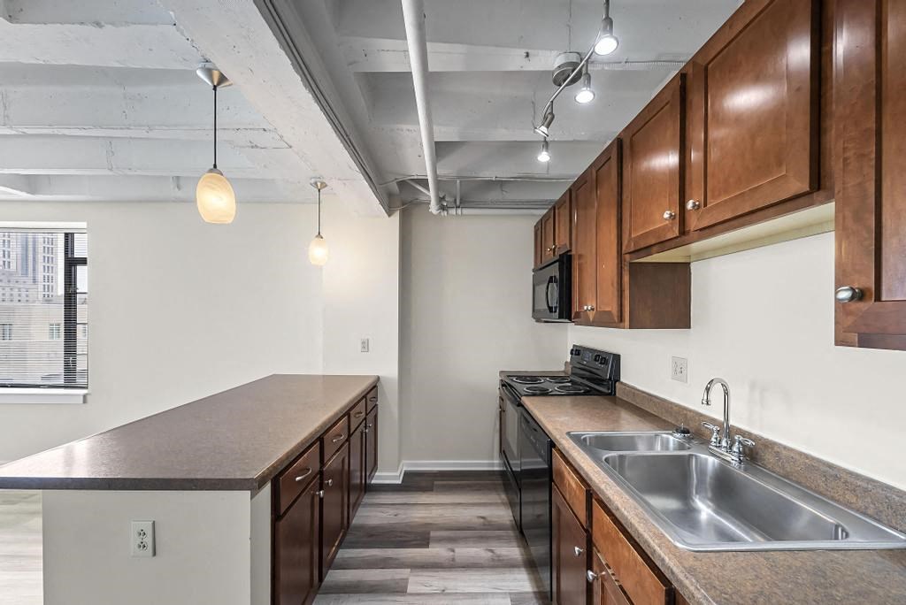 a kitchen with a sink a stove and a microwave