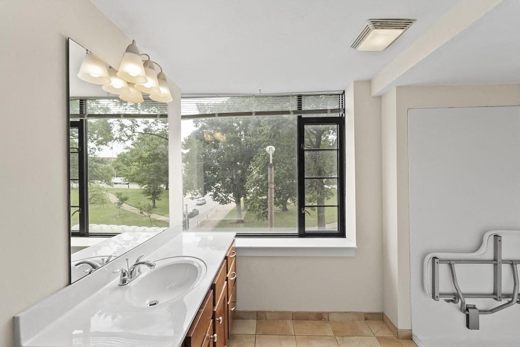 a bathroom with a large window and a sink