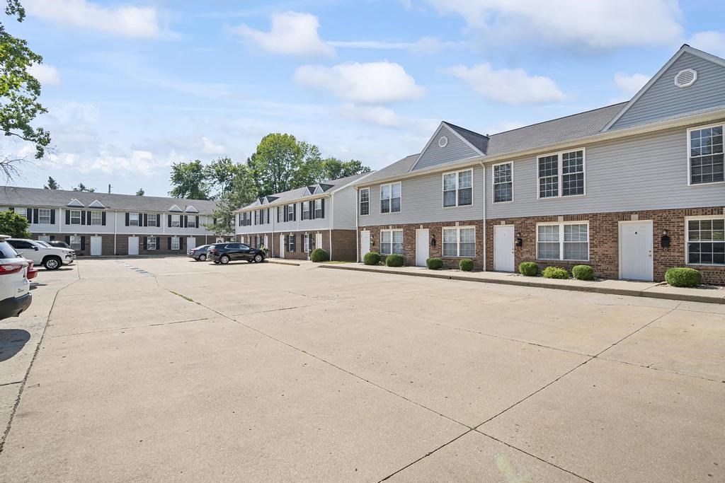 a parking lot in front of an apartment complex