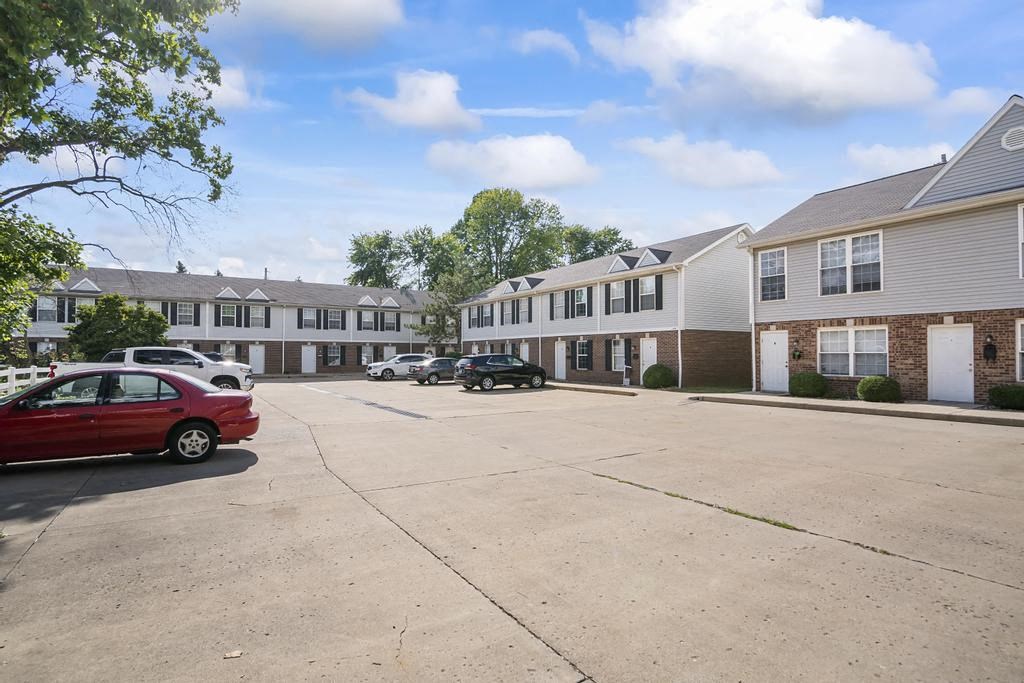 a parking lot in front of an apartment complex
