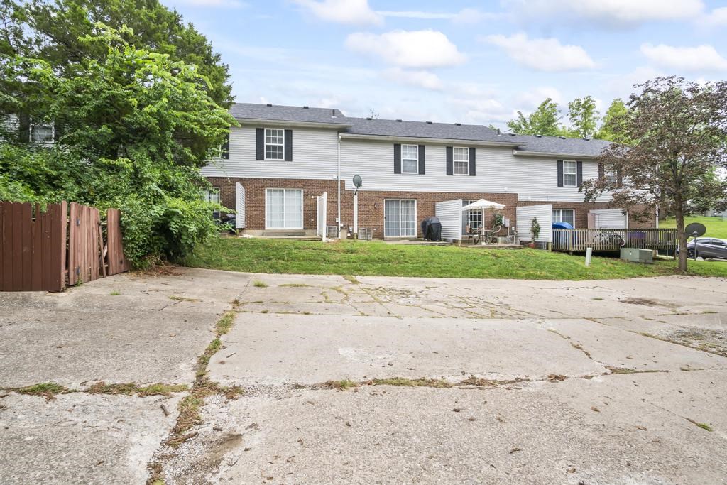 a house with a driveway and grassy area in front of it