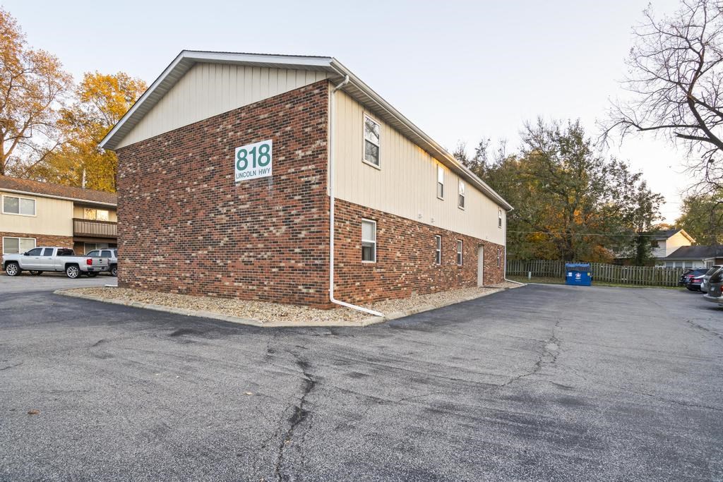 a parking lot in front of a brick building