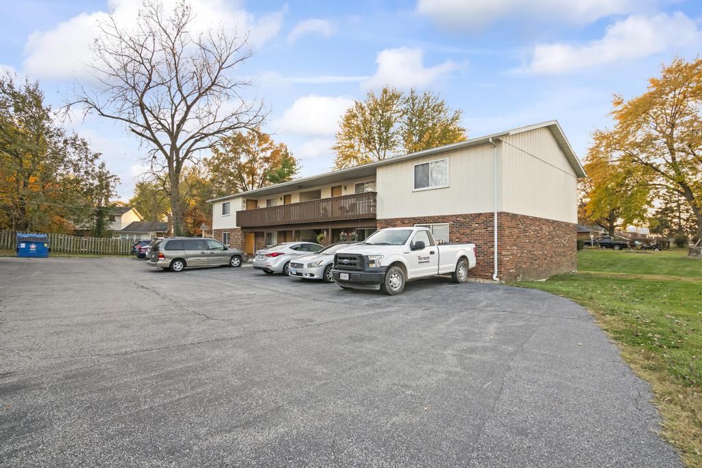 a parking lot with cars in front of a building