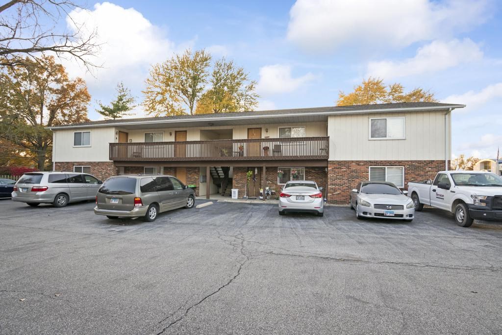 a parking lot with cars in front of a building