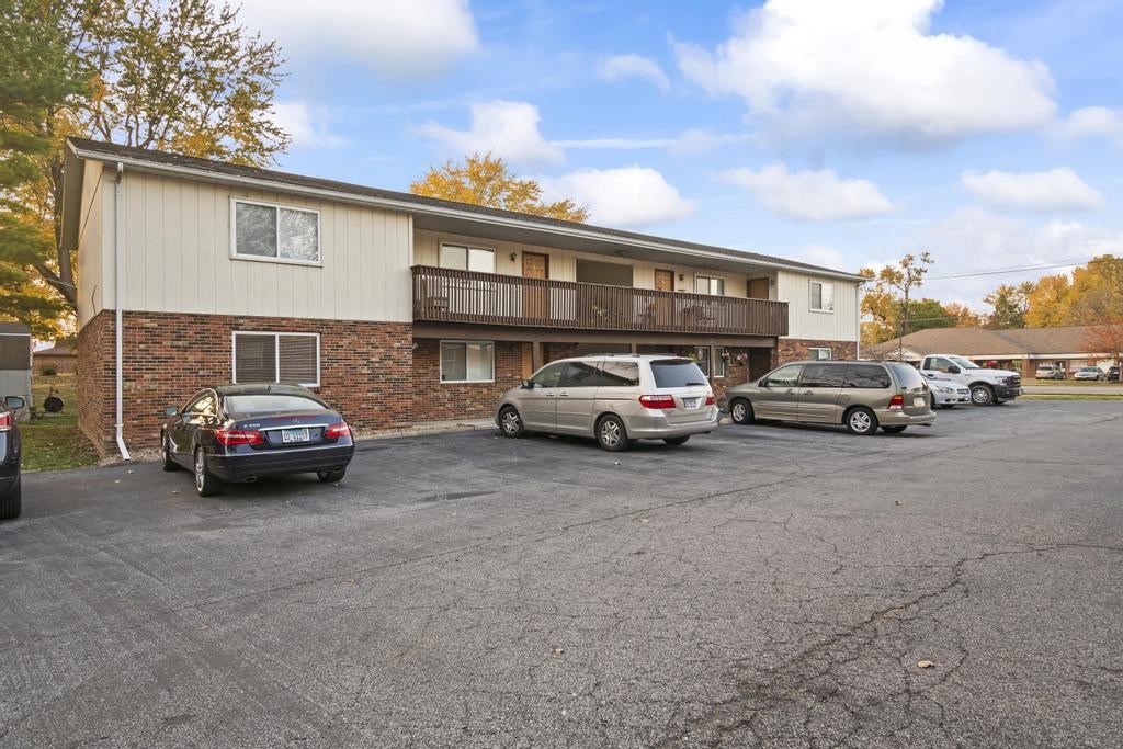 a parking lot with cars in front of a building