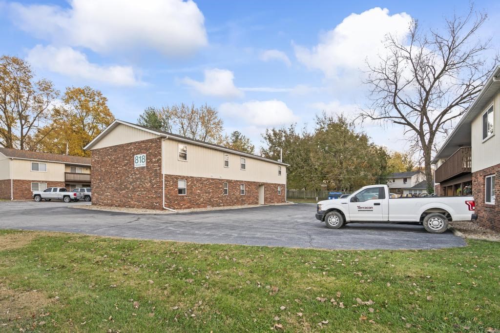 a truck parked in a parking lot in front of a building