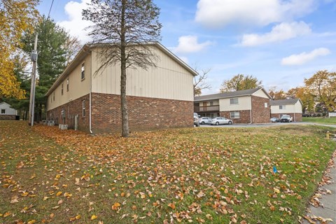 a house with a yard with leaves on the ground