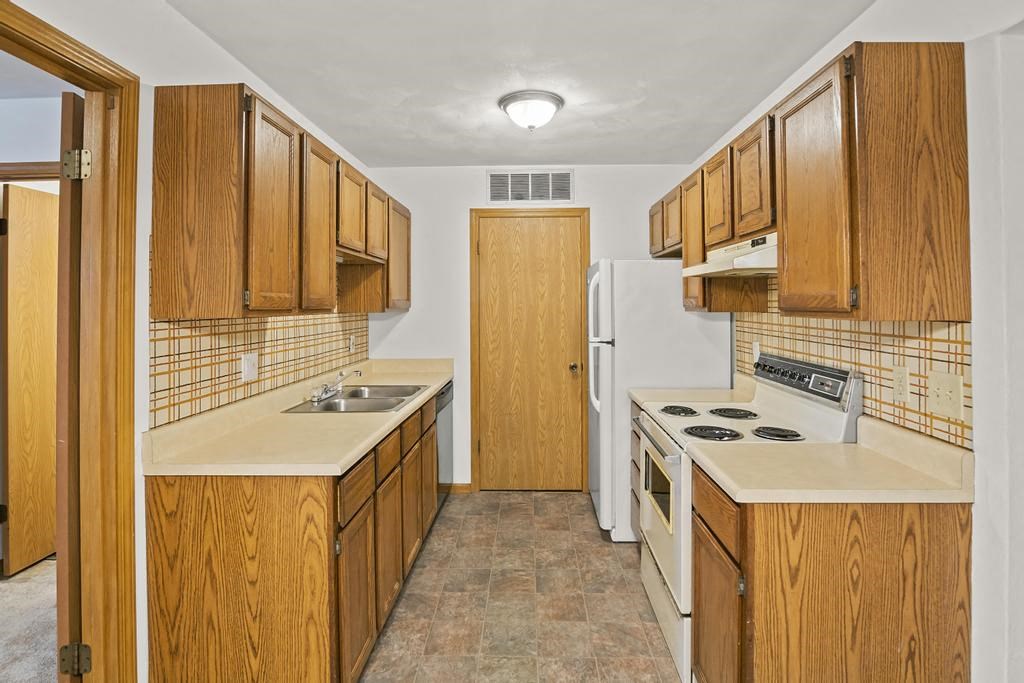 a kitchen with a stove and a refrigerator