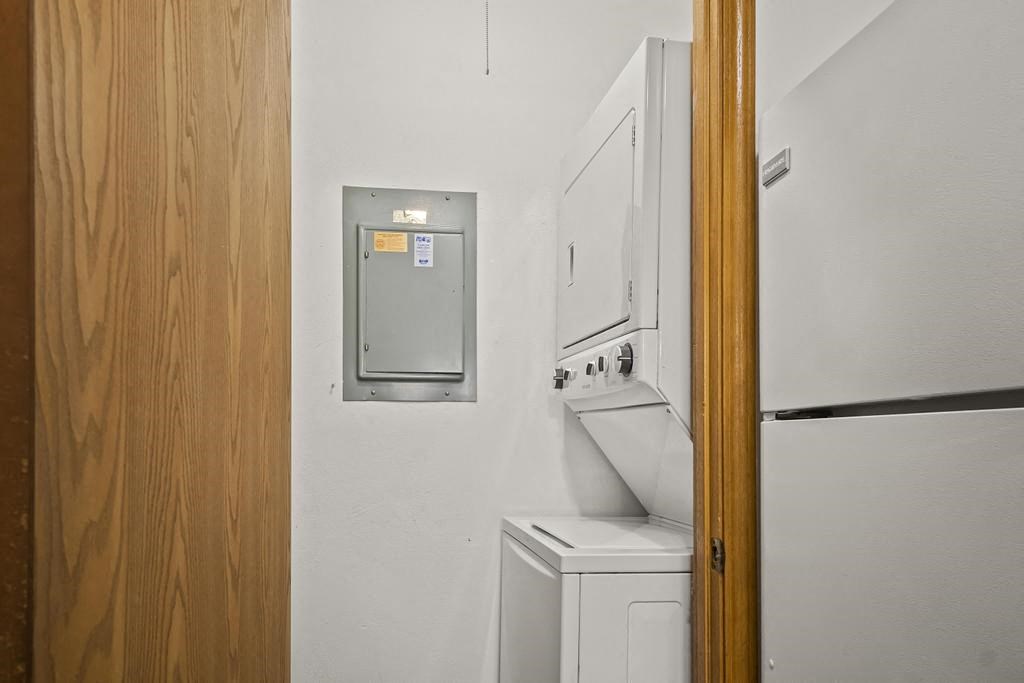 a white kitchen with a refrigerator and a washing machine