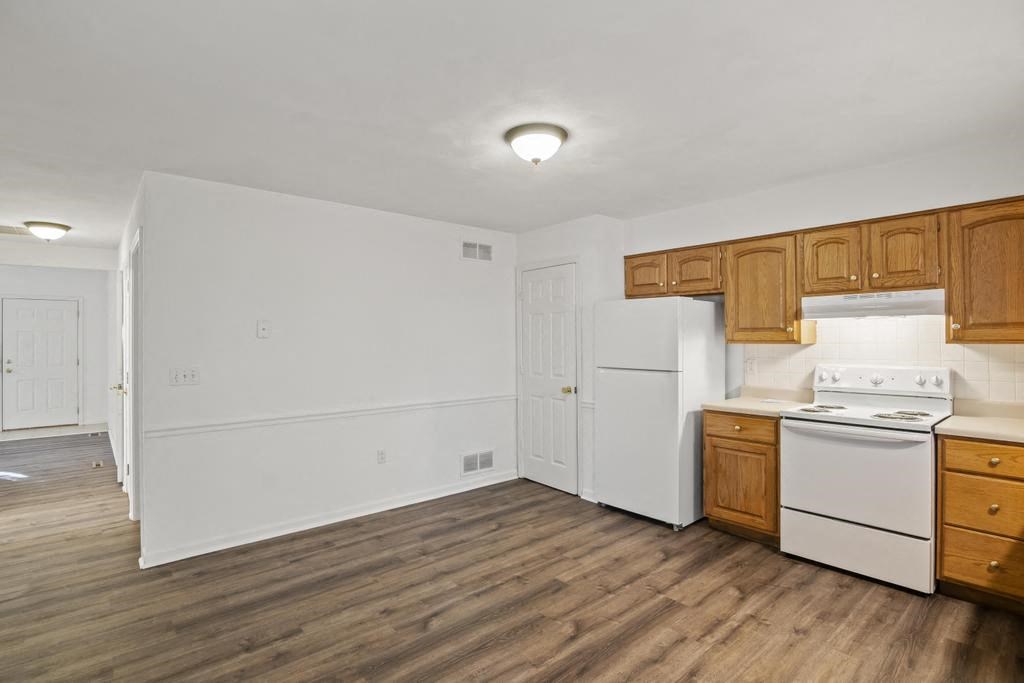 a kitchen with a stove and a refrigerator
