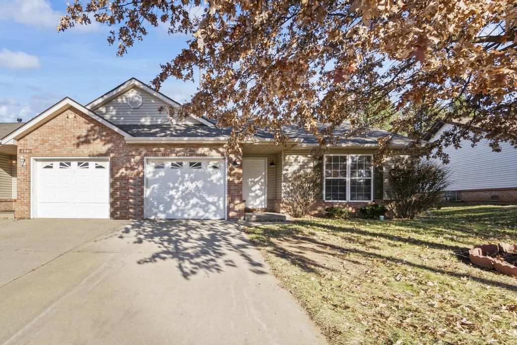 a brick house with a white garage door