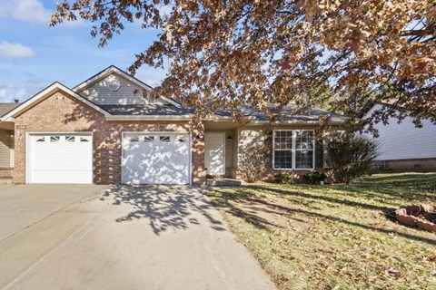 a brick house with a white garage door