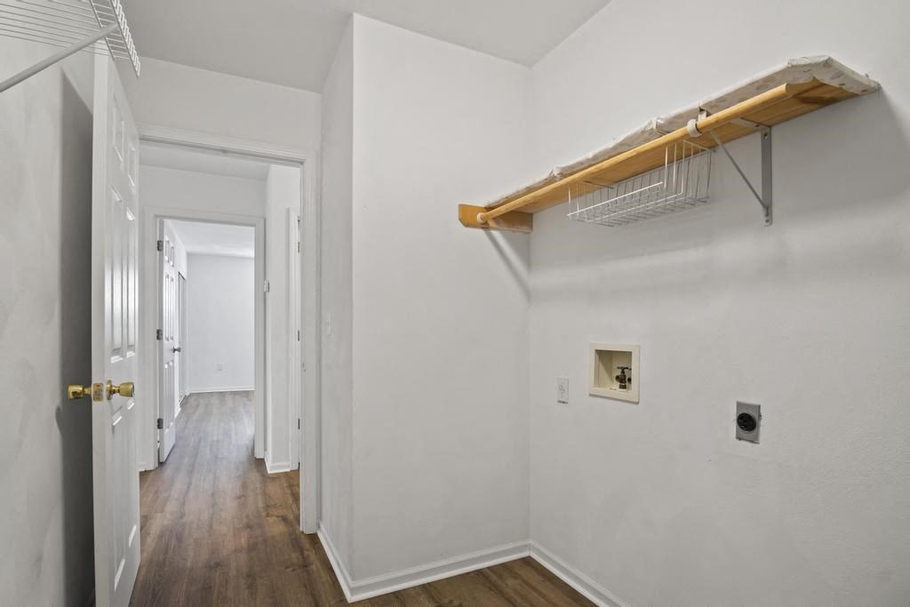 a room with white walls and a white door and a hallway with a white closet