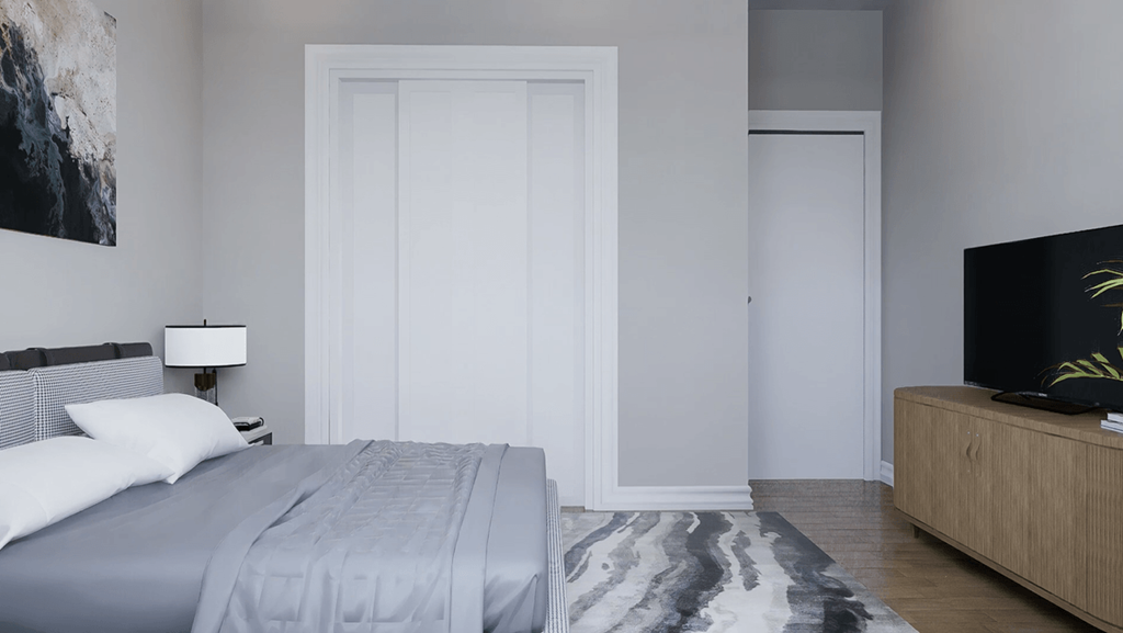 A bedroom with a bed, a nightstand, and a television.