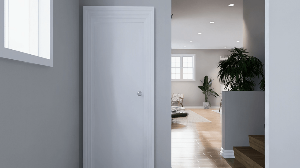 A white door is in the middle of a hallway.