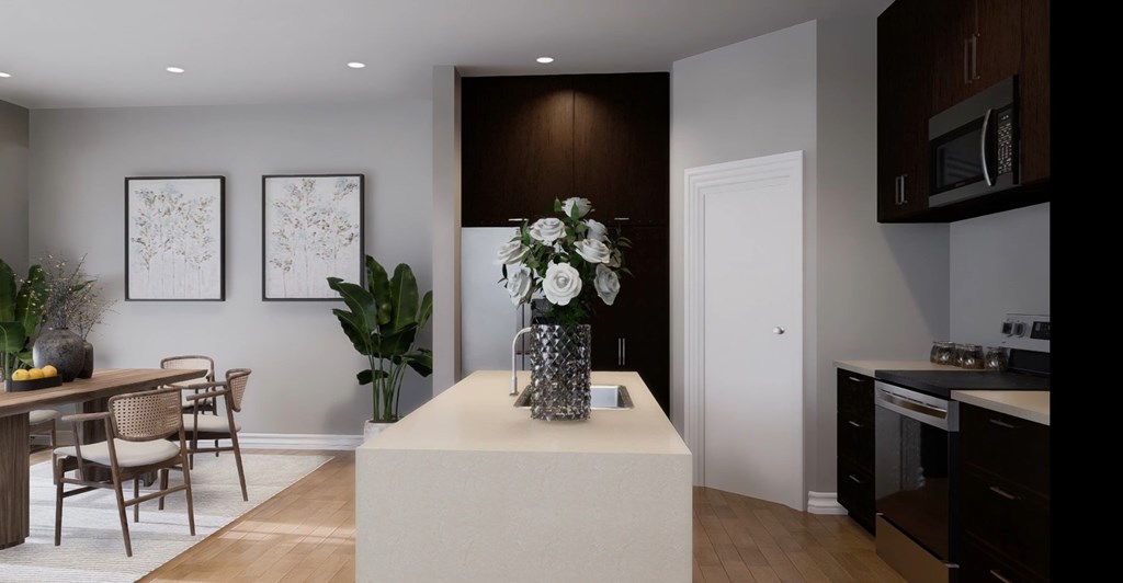 A modern kitchen with a dining table and chairs.