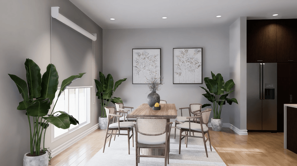 A dining room with a table set for four and a potted plant on the left.