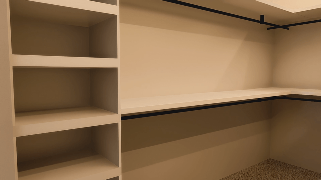 Empty shelves in a room with a black pipe on the ceiling.