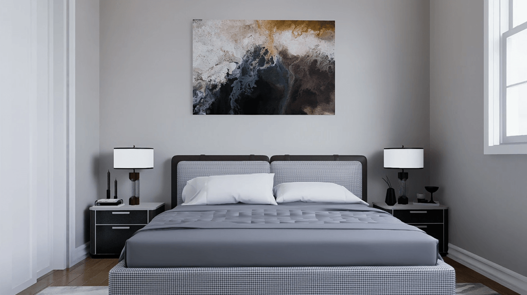 A bedroom with a large bed and a painting on the wall.