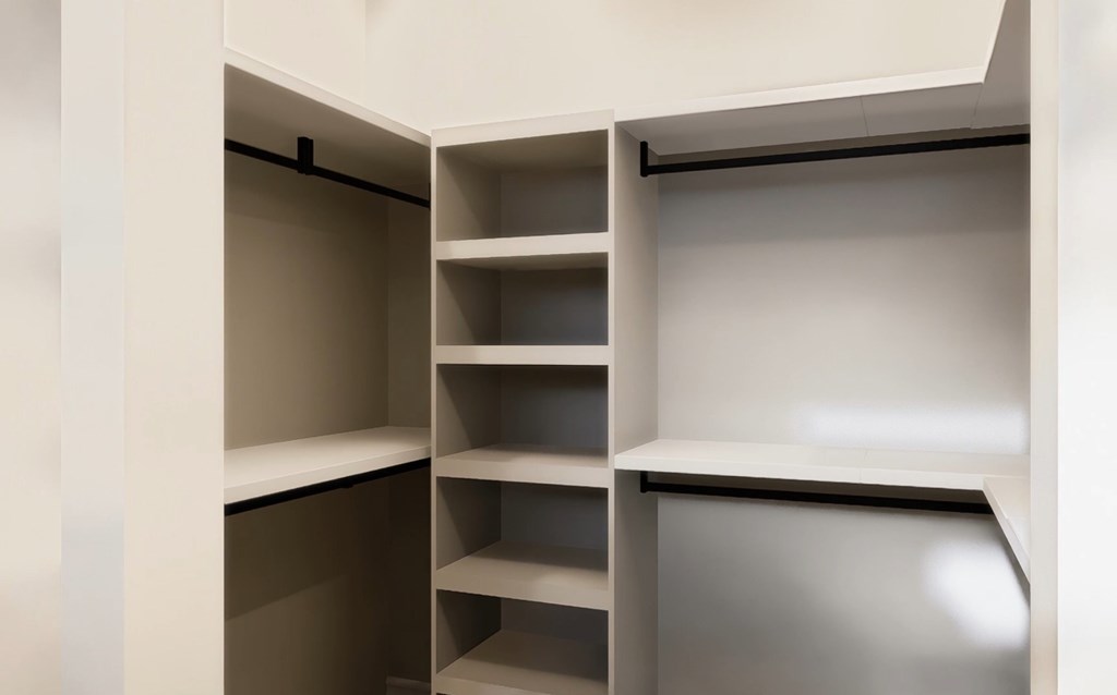 Empty shelves in a white storage unit.