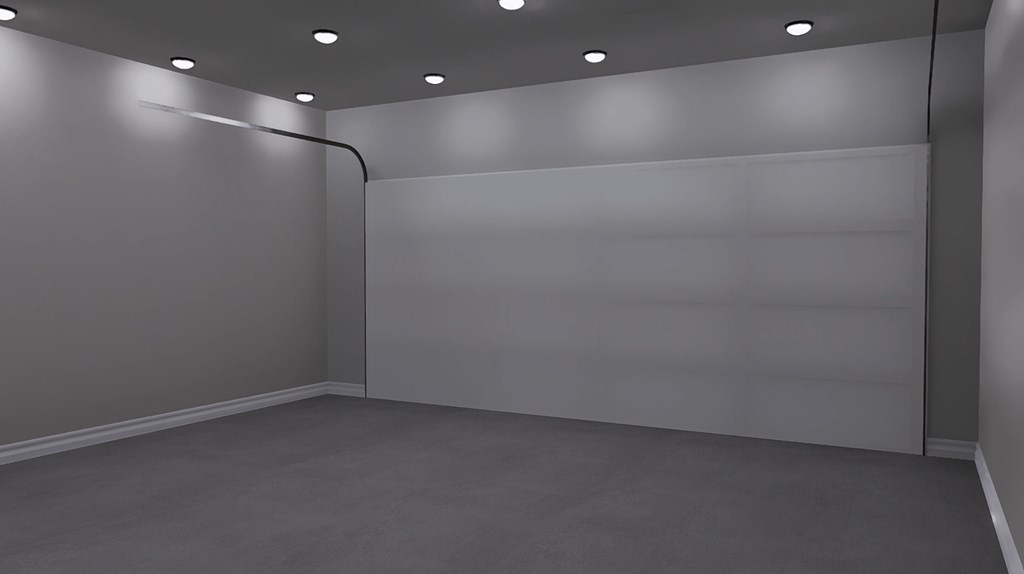 A room with a grey floor and walls, a white door, and a white ceiling with lights.