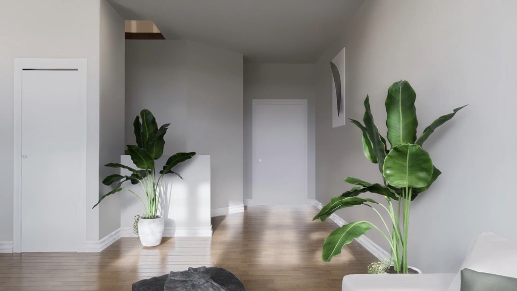 A room with two potted plants on the floor.