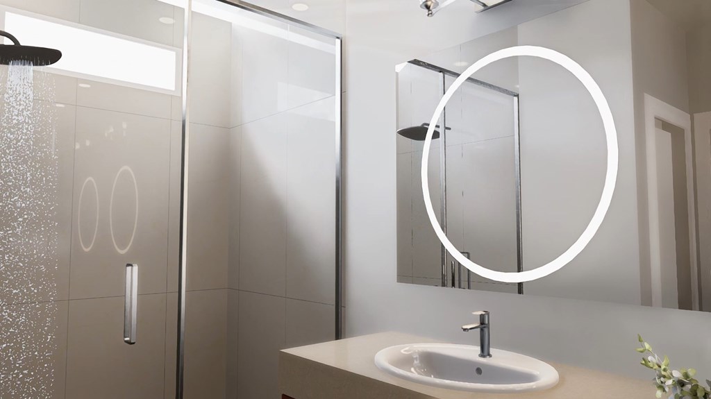 A modern bathroom with a sink, mirror, and shower.