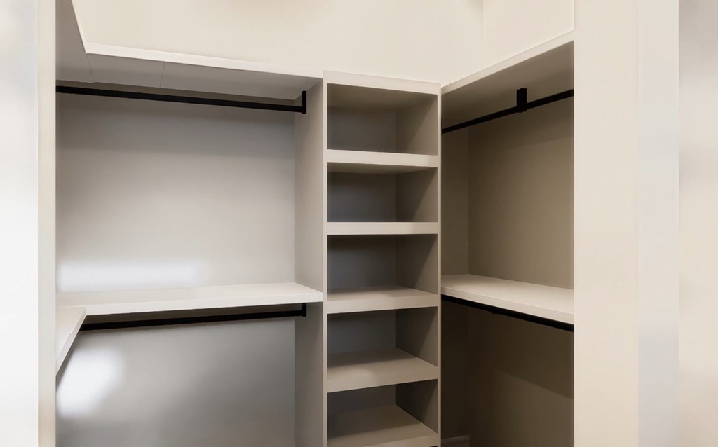 Empty shelves in a white pantry.