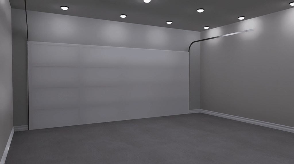 A room with a grey carpet and a white wall with a black pipe.